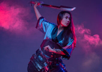 Eastern woman with samurai sword in fight stance