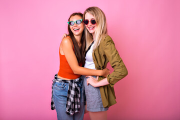 Two stylish hipster woman, best friends sister girls hugs and smiling