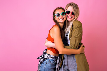 Two stylish hipster woman, best friends sister girls hugs and smiling