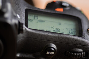Secondary LCD display of a modern DSLR camera with camera settings information turned on,