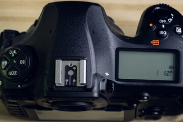 DSLR camera overhead view, second LCD display with settings information on the top, mode dials and...