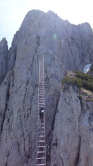 Via ferrata Donnerkogel Intersport klettersteig in Austrian Alps, Climber on 40 metres long ladder...