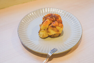 A cinnamon bun on plate