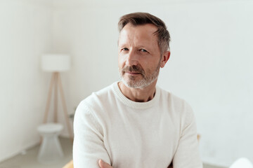 Serious middle-aged man looking speculatively at the camera