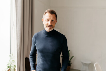Serious athletic middle-aged man staring intently at camera