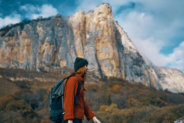 woman hiker backpack travel mountains clouds nature