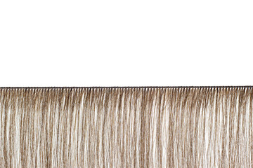 Real human hair extensions isolated on white background. The hairdresser wove a blank for hair extensions. - obrazy, fototapety, plakaty