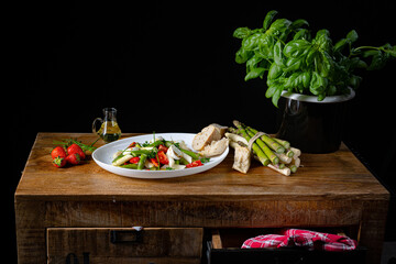 Fototapeta na wymiar Asparagus salad with strawberries, tomatoes and goat cheese