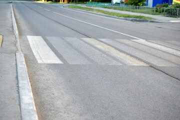 Asphalt road with markings and pedestrian crossing