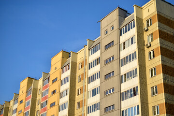 The surface and walls of a yellow high residential building