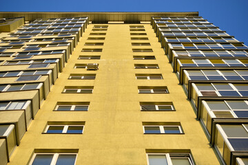 The surface and walls of a yellow high residential building