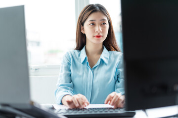 Portrait of young businesswoman concentrating on working