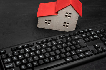 House model and keyboard. Real estate rental online. Search for housing on the Internet.