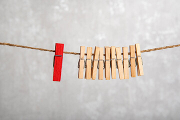 Clothespins on rope. Difference from others. Separate from the crowd. Leadership concept.