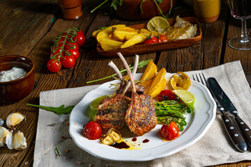 Lamb chops marinated in herbs with green asparagus and lime