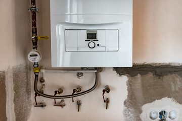 Installing of home gas boiler mounted on wall.