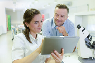 student showing digital tablet in lab classroom