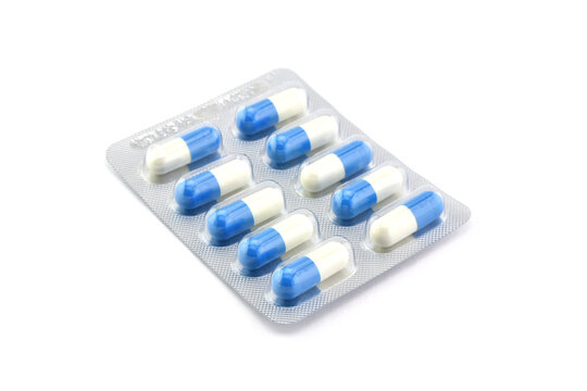 antibiotic pill capsules in aluminium blister foil packaging isolated on white