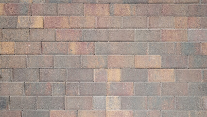 Obraz premium Stone beige paving stones of rectangular shape. Stone brick background. Top view