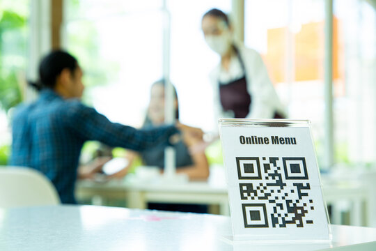 Customer using smartphone for scane qr barcode with menu online in restaurant.