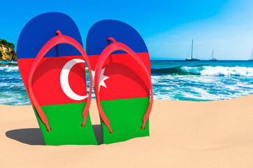 Flip flops with Azerbaijani flag on the beach. Azerbaijan resorts, vacation, tours, travel packages concept. 3D rendering