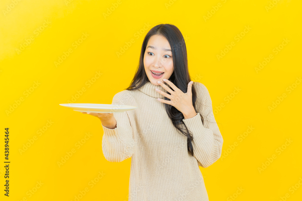 Wall mural portrait beautiful young asian woman smile with empty plate dish