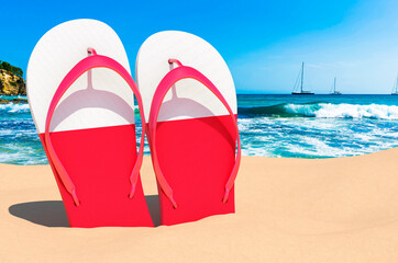 Fototapeta premium Flip flops with Polish flag on the beach. Poland resorts, vacation, tours, travel packages concept. 3D rendering