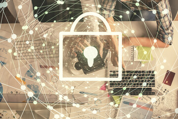 Double exposure of man and woman working together and lock hologram drawing. Security concept. Computer background. Top View.