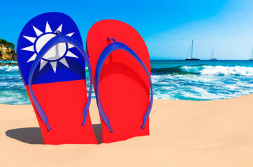 Flip flops with Taiwanese flag on the beach. Taiwan resorts, vacation, tours, travel packages concept. 3D rendering