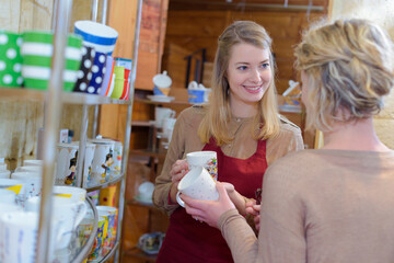 customer chooses ceramic cup in the store