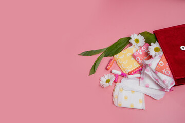 Menstrual tampons and pads in cosmetic bag. Menstruation cycle. Hygiene and protection.