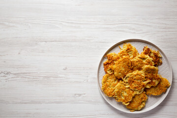 Homemade Potato Pancakes Latkes with Apple Sauce and Sour Cream on a white wooden table, top view. Flat lay, overhead, from above. Copy space.