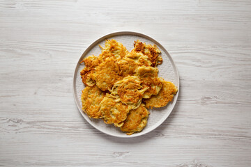 Homemade Potato Pancakes Latkes with Apple Sauce and Sour Cream on a white wooden background, top view. Flat lay, overhead, from above.