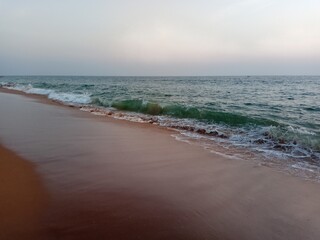 Beach at sunset with Red sand and Green waters