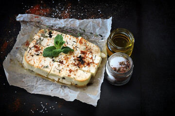 Baked feta cheese with spices. Healthy snack.