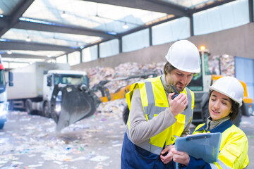 industrial engineers working in recycling plant with tablet