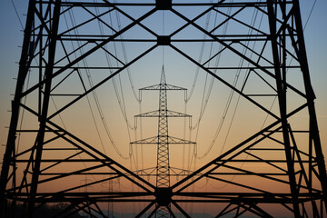 Electricity pylon (Strommasten) also overhead line pylon. Construction forms windows. Winter evening.