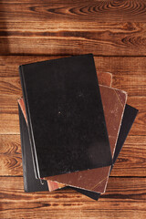 Old shabby books lying on a wooden surface