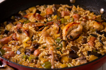 Spanish paella with rabbit, sausages, vegetables and artichokes. Traditional recipe from the Mediterranean area.