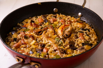 Spanish paella with rabbit, sausages, vegetables and artichokes. Traditional recipe from the Mediterranean area.