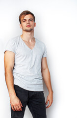 Obraz premium young handsome teenage hipster guy posing emotional, happy smiling against white background isolated, lifestyle people concept