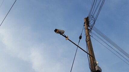 A security camera with a long shaft was installed on an electrical pole at the local community to...