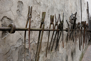 decorated facade with old agricultural tools in the small old village of Breno - Lombardy - Italy.
