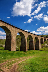 Fototapeta premium Old railway stone viaduct in the spring in sunny day.