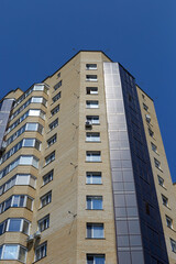 An ordinary residential high building against the blue sky
