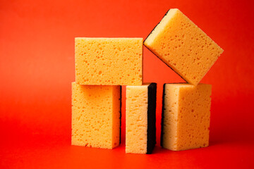 five sponges for cleaning on a red background