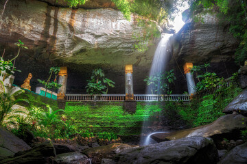 Wat Tham Heo Sin Chai, located at Ubon Ratchathani in Thailand. A path in temple leading to small cave, known Heaw Sinchai Cave and has a waterfall flowing down to be amazing natural attraction place.