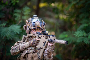 Female soldier is ready for fighting with gun. War, soldier army, gun and hostage rescue concept.