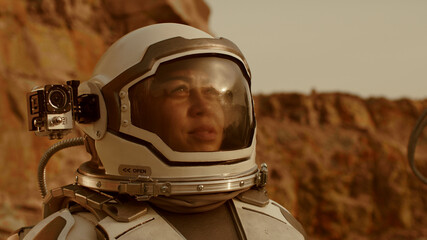 Female cosmonaut recording video during expedition on Mars