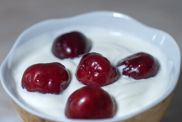 Cherries in cream on a light background